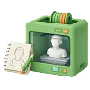 En grøn 3D-printer, der fremstiller en hvid figur, ved siden af en notesbog med en skitse af den samme person